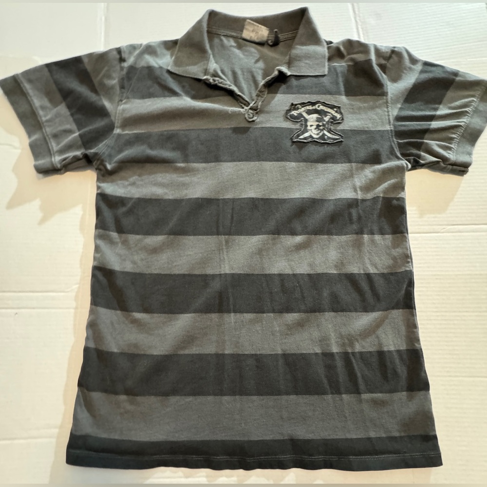 NWOT Men’s distressed Pirates of the Caribbean polo from Disneyland.